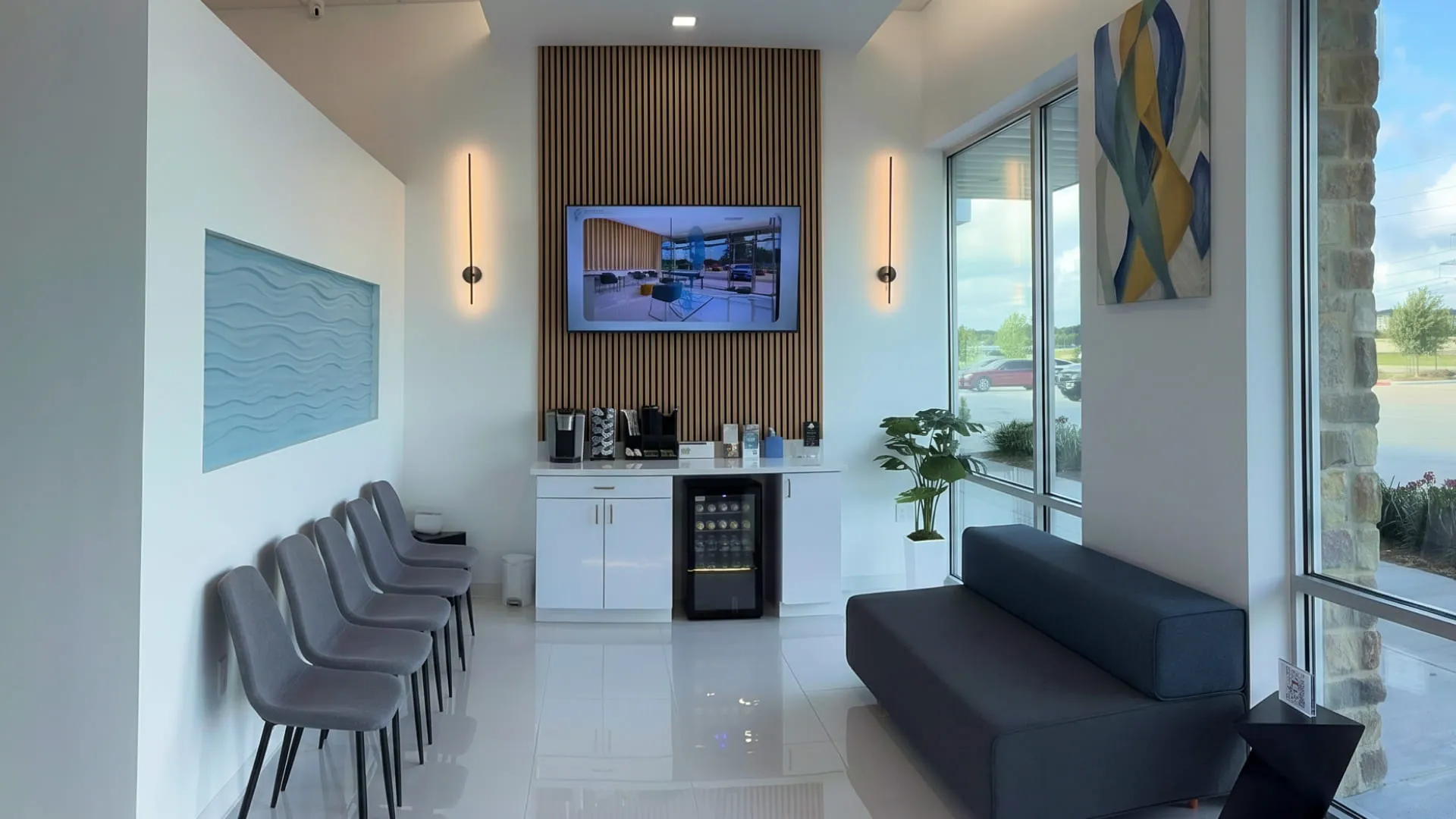 NuDentistry waiting lounge with navy sofa and coffee station