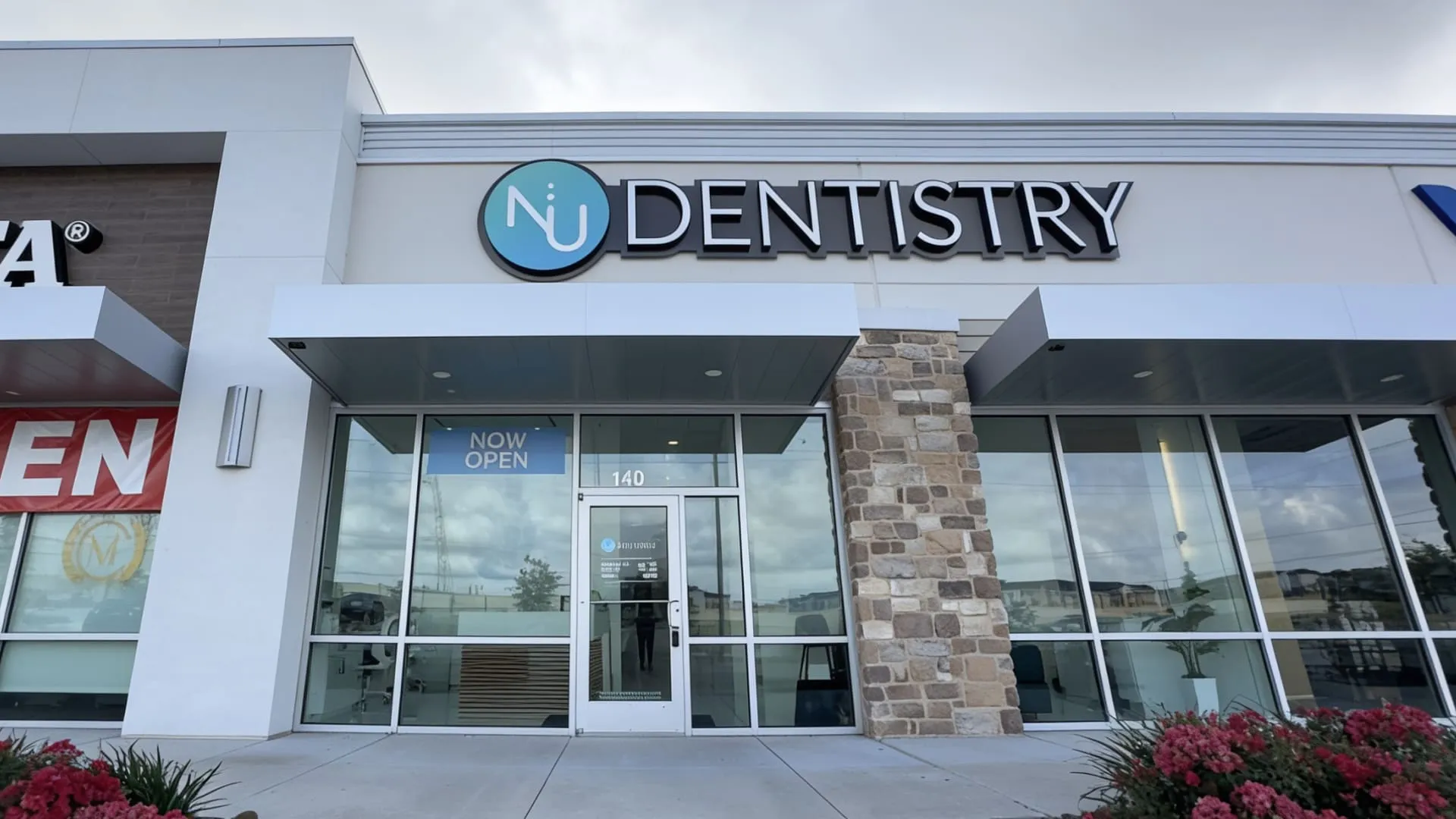 NuDentistry storefront entrance with illuminated logo signage